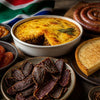 Traditional South African braai setup with coals and meat for authentic cuisine