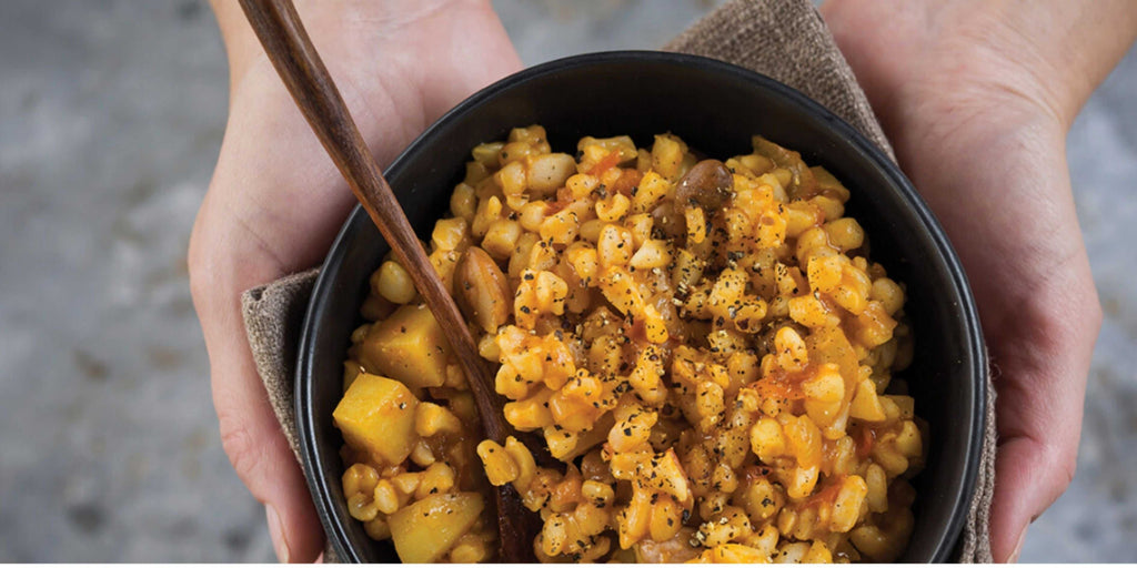 Traditional Nguni samp and beans dish with spices and sauces in a bowl