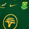Close-up of 2025 Nike Springboks Home Stadium jersey in green with gold Springbok, Nike swoosh, SA Rugby crest, and FNB logo embroidery.