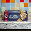 Bakers Cream Crackers 200g box on a marble countertop with colorful tiled background.