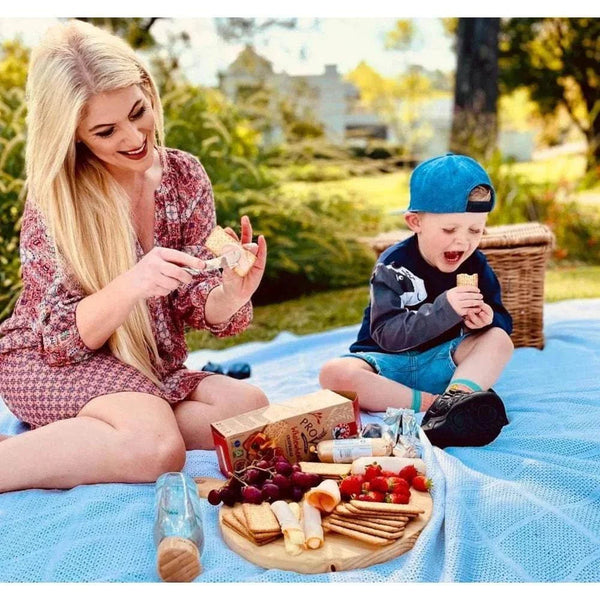 Bakers Provita biscuits - Wholewheat Crispbread 500g picnic scene with woman and child enjoying snacks outdoors.