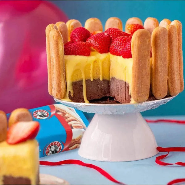 Bakers Boudoir Original Finger Biscuits arranged around a dessert with cream, strawberries, and layers, against a colorful background.