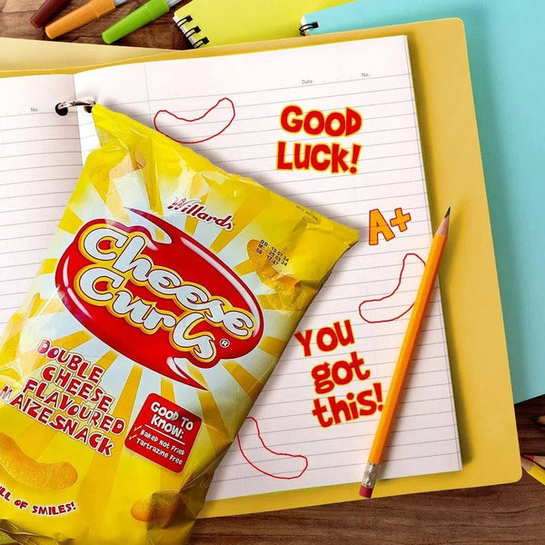 Willards Cheese Curls 150g bag with yellow packaging on a study desk with pencils and paper.