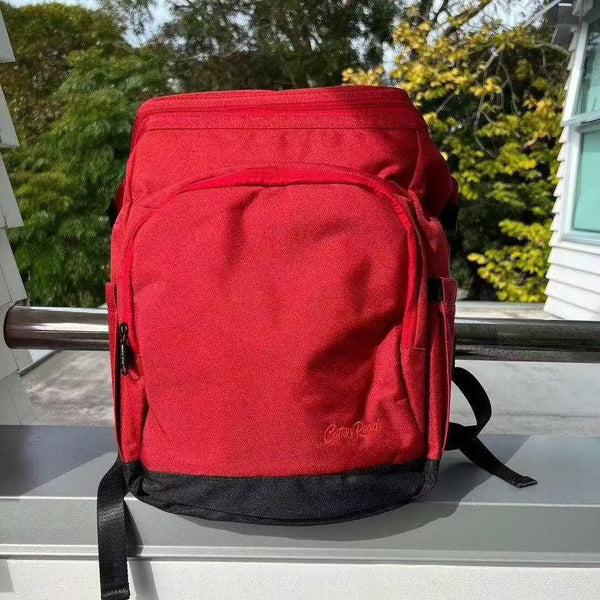Deep red Cotton Road Nappy Bag backpack with front zip, side bottle pockets, changing mat, and wet bag