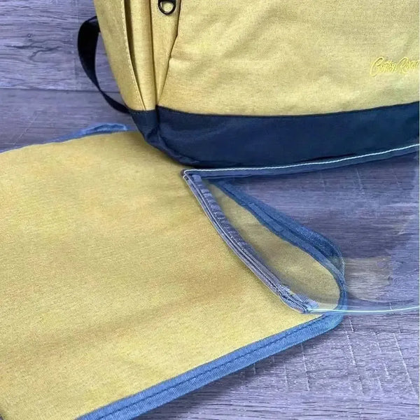 Cotton Road Nappy Bag backpack in mustard with front zip, side bottle pockets, and changing mat