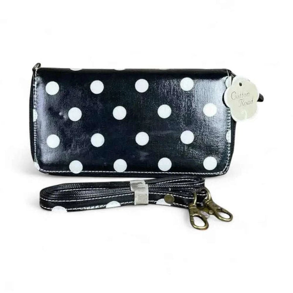Black sling wallet with large white dots, removable shoulder strap, zipper and clip compartments, 20cm x 11cm.