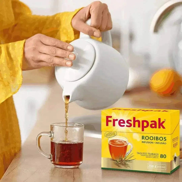 Freshpak Rooibos Tea 80's box with tea being poured into a glass cup