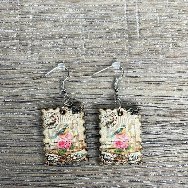 Hanging earrings featuring postage stamp design with bird in a cage, nickel free, made in South Africa