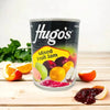 Hugo's Mixed Fruit Jam 450g jar with assorted fruits background