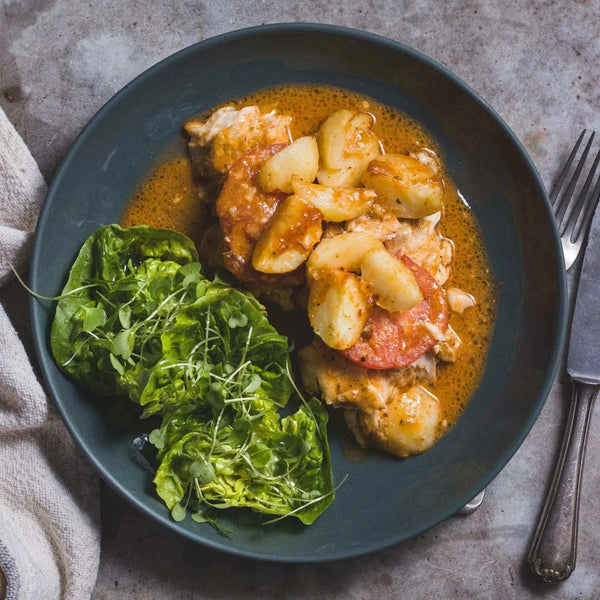 Plate of food featuring chicken and vegetables coated in Ina Paarman Peri-Peri sauce.