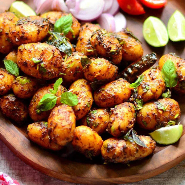 Ina Paarman Potato Spice with seasoned potatoes, garnished with herbs and limes.