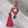 Red heart keyring with "Believe" text and large green heart background, 50mm size