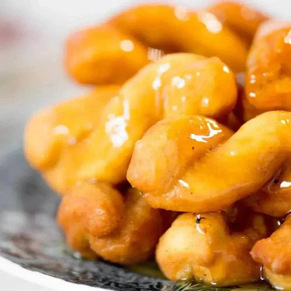 Pack of 12 freshly made Koeksisters ready to eat, golden fried dough soaked in sweet syrup, perfect for weekend treats and gatherings