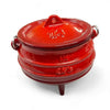 Red enamel 3-legged cast iron pot with lid, ideal for outdoor potjie cooking.