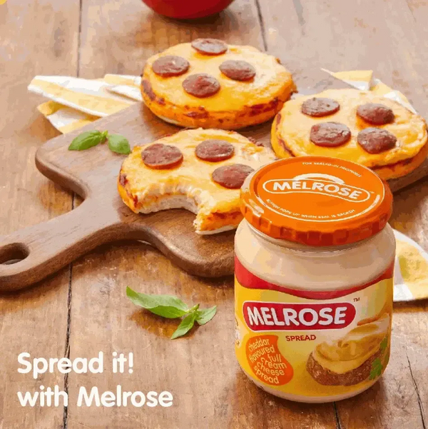 Melrose Cheese Spread - Cheddar 400g jar with toasted bagels topped with spread and pepperoni slices, wooden board background.