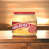 Melrose Cheese Spread Sweet Milk 250g jar on wooden table with soft background lighting.