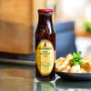 Mrs Balls Chutney Hot 470g jar on a kitchen counter, perfect for spicing up dishes.