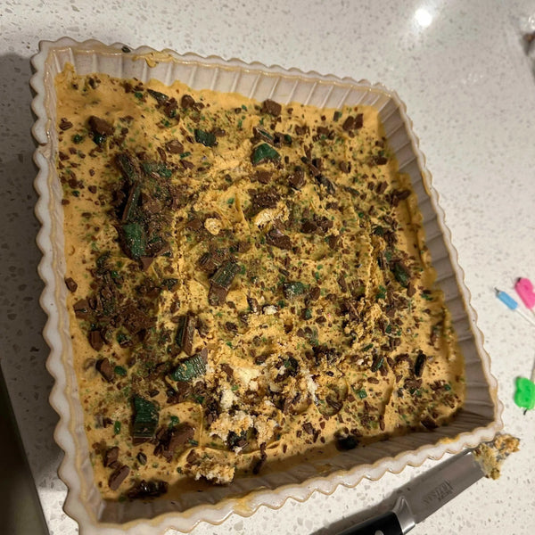Peppermint Crisp Tart with chocolate and mint topping in square dish.