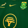 Close-up of 2025 Nike Springboks Home Stadium jersey in green with gold embroidered Springbok, Nike swoosh, and South Africa Rugby crest.