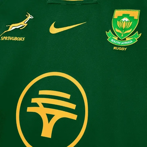 Close-up of 2025 Nike Springboks Home Stadium jersey in green with gold embroidered Springbok, Nike swoosh, and South Africa Rugby crest.