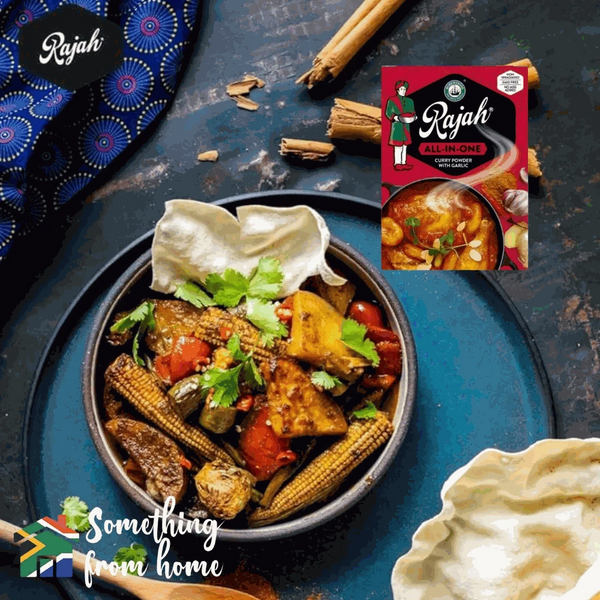 Rajah Curry Powder 100g pack enhancing colorful vegetable curry with spices.