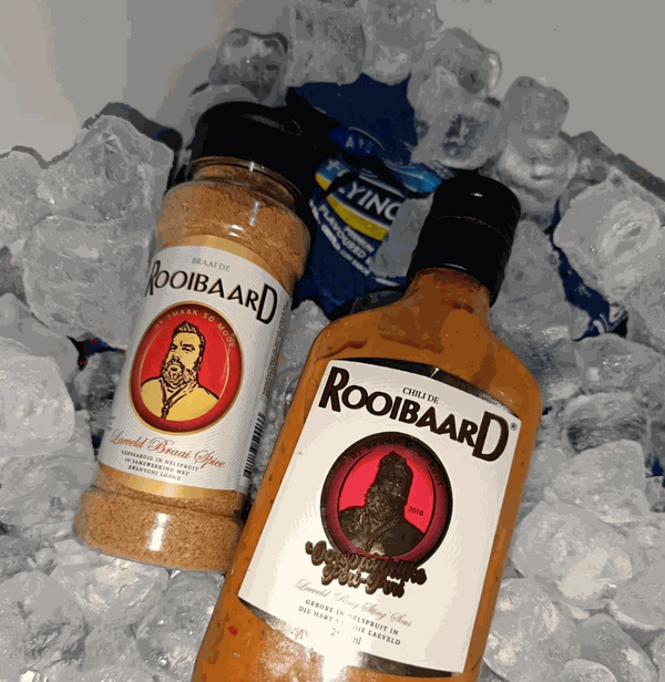 Rooibaard Spice 170ml bottle surrounded by ice, ideal for seasoning fish, chicken, pork, mutton, steak, and more.
