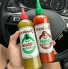 Rooibaard Tabaardsco Groen Sauce and Red Sauce bottles held inside a car.