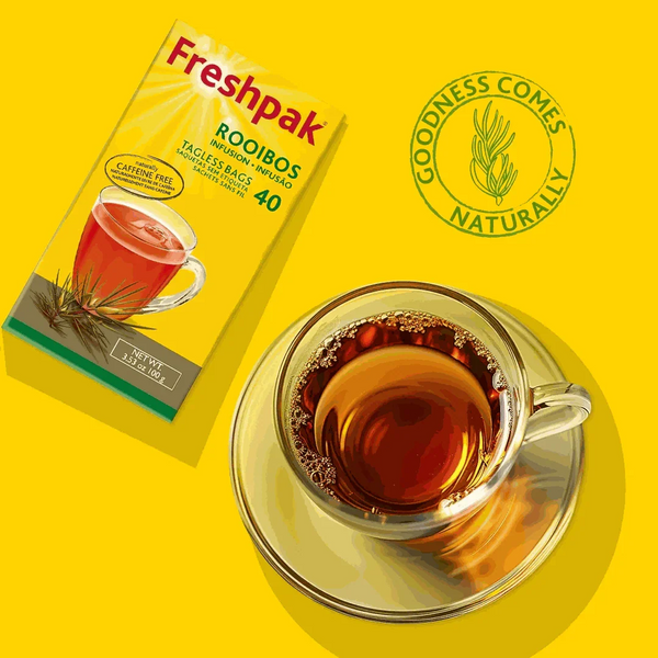 Freshpak Rooibos Tea 80's box with a cup of brewed rooibos tea on a yellow background, highlighting natural goodness and caffeine-free attributes