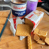 Silverleaf Guava Halves in Syrup can with biscuits and evaporated milk on a wooden table.