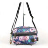 Cotton Road canvas sling bag with purple flowers, multiple zip compartments, adjustable strap