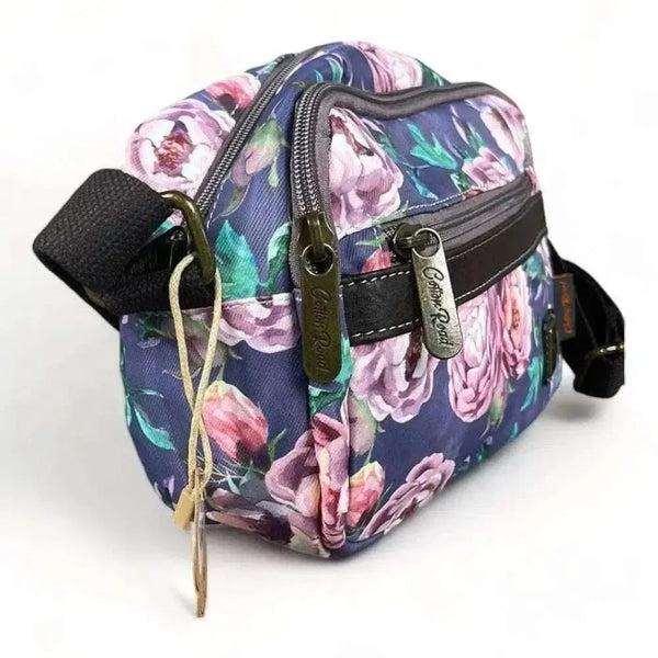 Canvas sling bag with purple flowers and multiple zip compartments