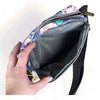 Canvas sling bag with purple flowers and adjustable shoulder strap