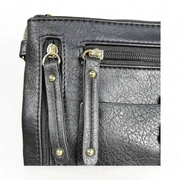 Black PU leather sling bag with adjustable strap and multiple zip compartments