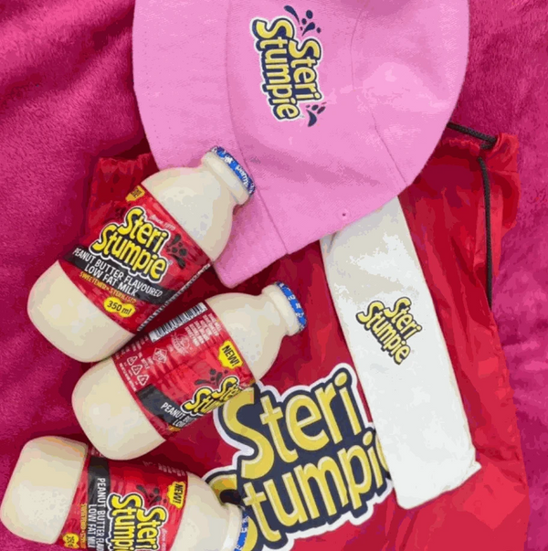 Steri Stumpie Peanut Butter Flavoured Low Fat Milk bottles with branded merchandise on display.