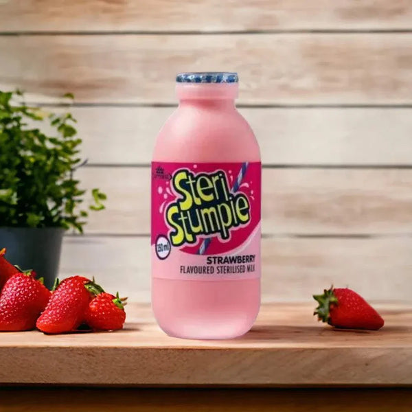 Steri Stumpie 350ml strawberry flavoured low fat milk bottle with fresh strawberries on wooden surface