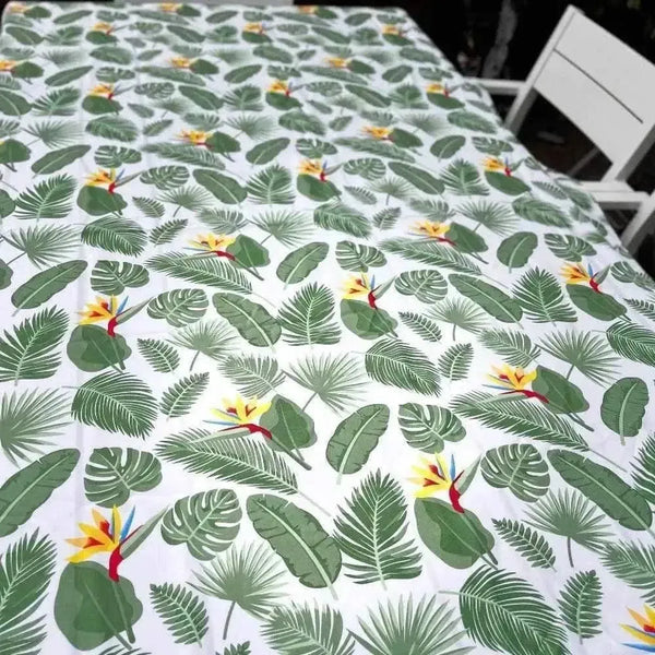 White tablecloth with Delicious Monster and Strelitzia floral print on dining table