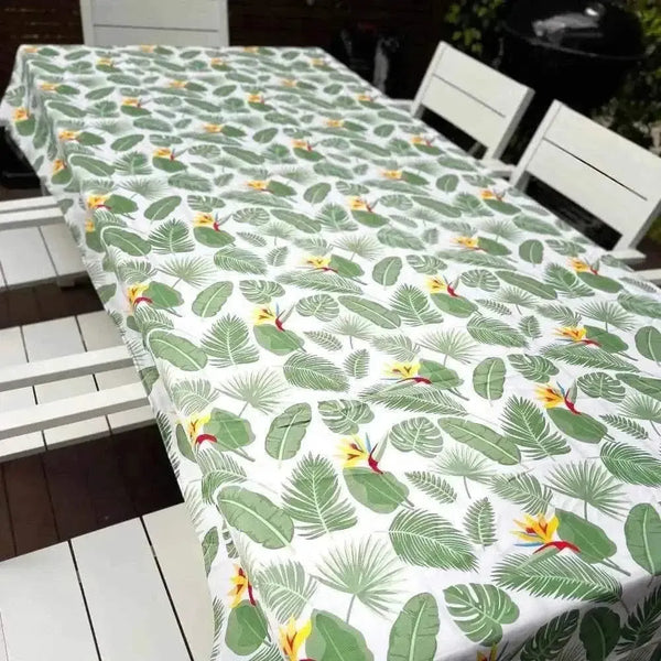White tablecloth with Delicious Monster and Strelitzia flower print on dining table