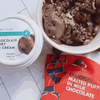 Woolworths CHUCKLES® Chocolate & Malted Puffs 250g next to chocolate ice cream in a bowl.