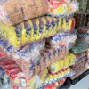 Stacked bulk packages of Yank Snacks Maize Puffs Fruit Chutney flavor in clear plastic bags.