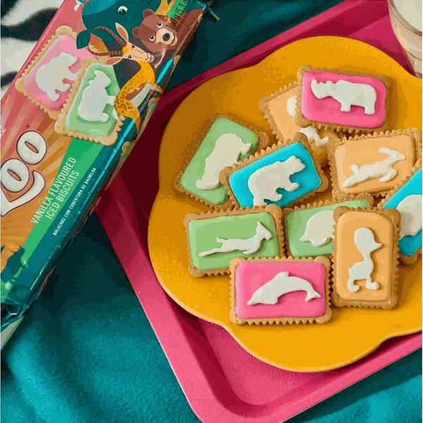 Colorful Bakers Zoo Biscuits with iced animal shapes on vibrant backgrounds, 150g pack