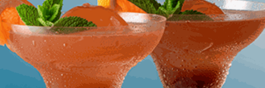 Refreshing Kolarita cocktail made with Roses Kola Tonic Cordial, grapefruit juice, gin lemonade, garnished with grapefruit peel and mint leaf