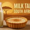 Freshly baked traditional South African milk tart with cinnamon topping on a wooden surface