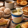 Condensed milk cans and South African traditional dessert ingredients on kitchen counter