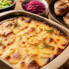 Golden cheesy South African potato bake with creamy layered potatoes in a baking dish