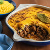 Golden baked beef bobotie topped with spiced egg custard in a traditional South African dish
