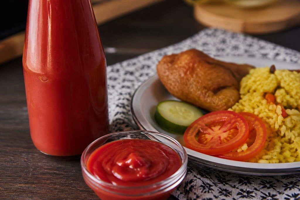 Thick, rich South African tomato sauce in a clear glass bowl showcasing its deep red color and smooth texture