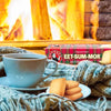 Bakers Eet-Sum-Mor 200G biscuits with tea by a cozy fireplace.