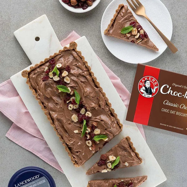 Bakers Chockits - Original 200g pack with chocolate tart and nuts on a serving board.