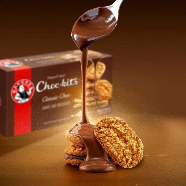 Bakers Chockits Original 200g pack with smooth chocolate being poured over cookies.