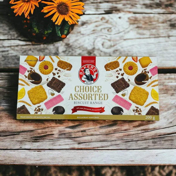 Bakers Choice Assorted - 200g box of assorted cookies on a wooden table with flowers.